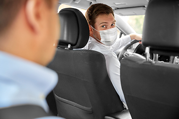 Image showing taxi driver in face protective mask driving car