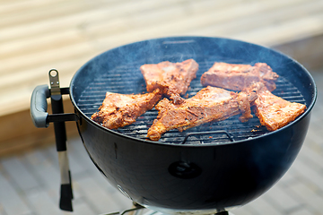 Image showing close up of barbecue meat roasting on grill