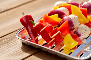 Image showing close up of vegetables on skewers on foil grill