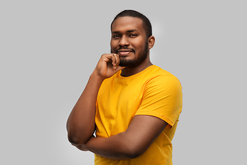 Image showing african american man in yellow t-shirt over grey