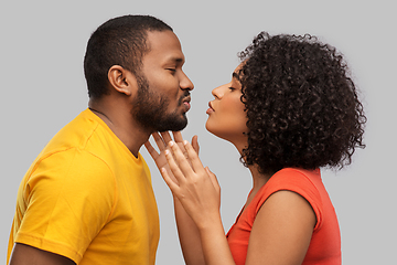 Image showing happy african american couple reaching for kiss