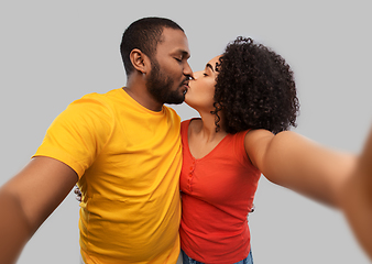 Image showing african american couple taking selfie and kissing