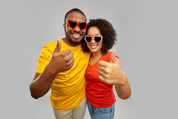 Image showing happy african couple in heart shaped suglasses