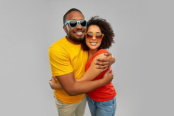 Image showing happy african couple in sunglasses hugging