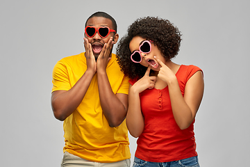 Image showing happy african couple in heart shaped sunglasses