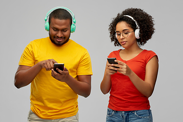 Image showing african couple with headphones and smartphones