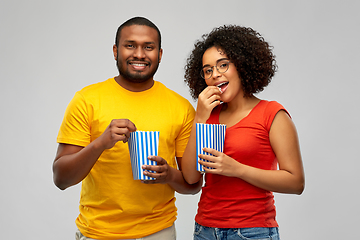 Image showing happy african american couple eating popcorn