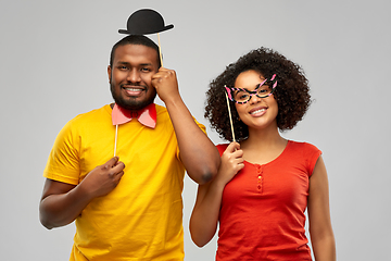 Image showing happy african american couple with party props