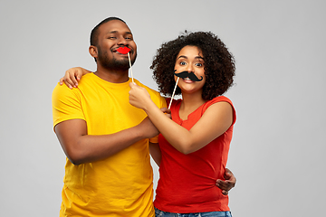 Image showing happy african american couple with party props