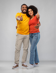 Image showing happy african american couple showing thumbs up