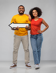 Image showing happy african american couple holding arrow