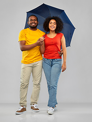 Image showing smiling african american couple with umbrella