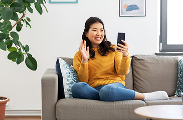 Image showing woman with smartphone having video call at home