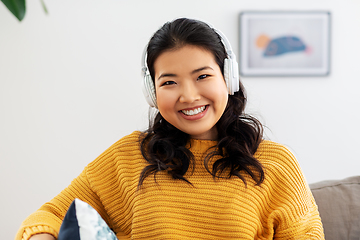 Image showing woman in headphones listening to music at home