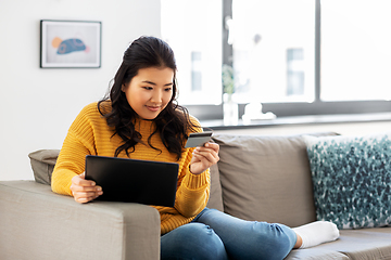 Image showing asian woman with tablet pc and credit card at home