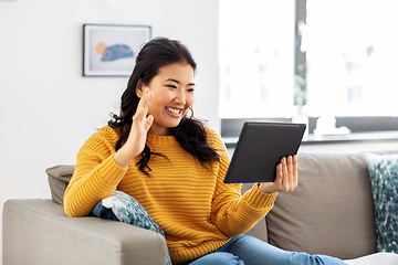 Image showing woman with tablet pc having video call at home