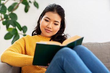 Image showing asian young woman reading book at home