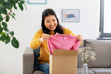 Image showing happy asian young woman with parcel box at home