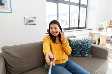 Image showing woman taking selfie and showing peace at home