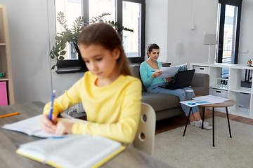 Image showing mother working and daughter studying at home