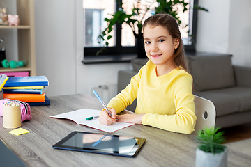 Image showing student girl writing to notebook at home