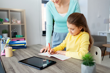 Image showing mother and daughter with tablet pc doing homework