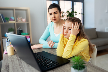 Image showing mother and daughter with laptop doing homework