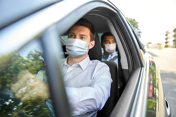 Image showing taxi driver in face protective mask driving car