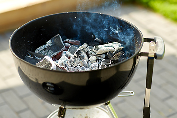 Image showing charcoal smoldering in brazier outdoors