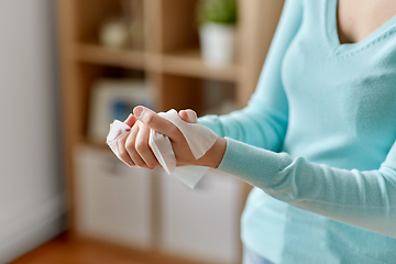 Image showing woman cleaning hands with antiseptic wet wipe