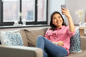 Image showing asian woman taking selfie with smartphone at home