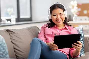 Image showing asian woman with headphones and tablet pc at home