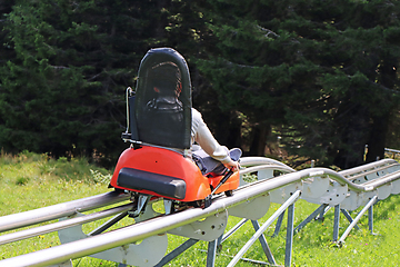 Image showing Little boy enjoying a summer fun roller alpine coaster ride