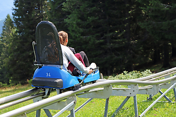 Image showing Two young girls enjoying a summer fun roller alpine coaster ride