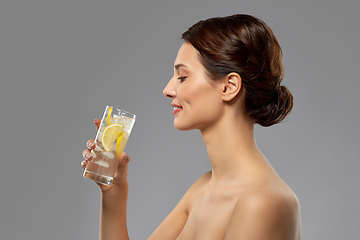 Image showing woman drinking water with lemon and ice