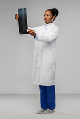 Image showing african american female doctor looking at x-ray