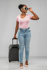 Image showing happy african woman in sunglasses with travel bag