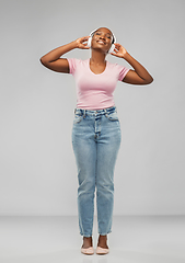 Image showing african woman in headphones listening to music