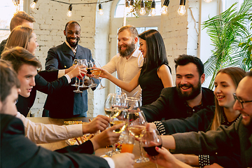 Image showing Happy co-workers celebrating while company party and corporate event