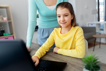 Image showing mother and daughter with laptop doing homework