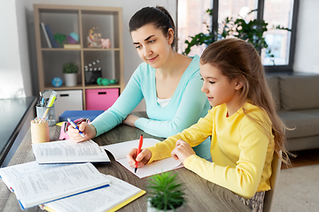 Image showing mother and daughter doing homework together