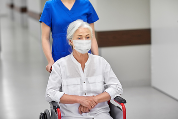 Image showing senior woman in mask in wheelchair at hospital