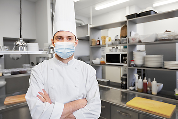 Image showing male chef cook in face mask at restaurant kitchen