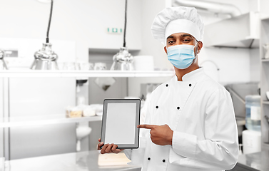 Image showing male chef in face mask with tablet pc at kitchen