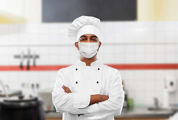 Image showing male chef in face mask at restaurant kitchen