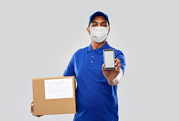 Image showing delivery man in mask with cellphone and parcel box