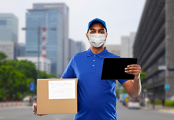 Image showing delivery man in mask with tablet pc and parcel box