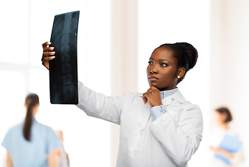 Image showing african american female doctor looking at x-ray