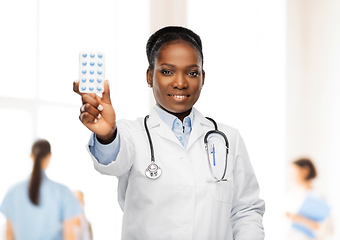 Image showing african american female doctor with medicine pills