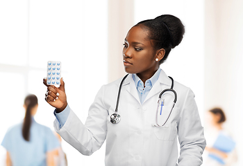 Image showing african american female doctor with medicine pills